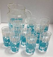 Full set of one pitcher and 8 drinking glasses with turquoise and white mid century pattern