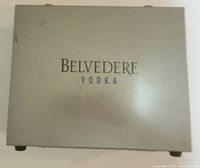 Closed metal case with Belvedere Vodka logo on top.