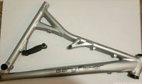 Side view of the silver Gary Fisher HifiPlus mountain bike frame showing welds, frame geometry, and minor surface scratches.