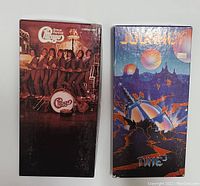 Photo showing front of two CD box sets: Chicago box set with band group portrait and Journey box set with 'Time' album cover art.