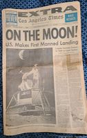 Front page with headline 'On The Moon! U.S. Makes First Manned Landing' and photo of lunar module on moon surface.
