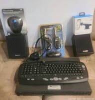 Photo shows an assortment of electronics including a wireless keyboard, a sealed wireless trackball mouse, a pair of walkie talkies with antenna deterioration, and a Motorola speaker dock in box.