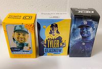 Three boxed Tampa Bay Rays baseball player bobbleheads: Evan Longoria in Bright House box, Tyler Glasnow in Bayfront Health box, and Carl Crawford in Duke Energy box.