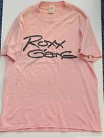 Full front view of pink Roxx Gang concert T-shirt showing print and overall condition