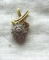 Front view of 10K gold diamond pendant showing diamonds and gold design details.