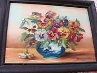 Framed oil painting on glass of colorful floral bouquet in blue vase signed Gladys M. Lawrence 1951.