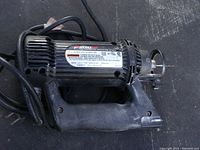Side view of RotoZip Spiral Saw with power cord and safety guard, showing model label and handle.