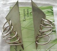 Front view of both geometric sterling silver earrings with overlapping circular loops and 925 Mexico stamp card underneath.