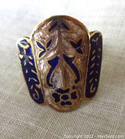 Top view showing the detailed blue enamel floral and leaf design on gilded sterling silver ring face, measuring about 22 x 20 mm.