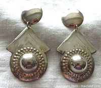 Front view of the pair of large vintage sterling silver earrings showing the geometric and circular dome design with raised dots and round stud attachment.