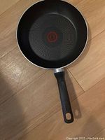 Top-down view of 9 inch frying pan showing interior and handle with Thermo-Spot heat indicator.