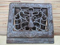 Front view of the antique metal vent showing the ornate Art Nouveau decorative grille and surrounding floral border.
