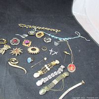 Overall view of assorted jewelry pieces laid out on black fabric