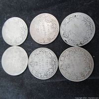 Overview of six Canadian silver 25 cent coins showing reverse sides with maple leaf wreath design, years and denominations visible.