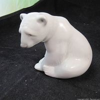 Front angle showing the bear's face and seated pose on black background.