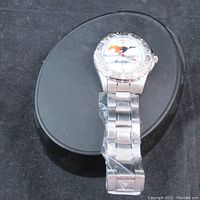 Full view of the Mustang official licensed wristwatch on display stand, showing the metal bracelet and watch face.