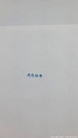 Four small, calibrated blue gemstones laid in a row on a white background, showing consistent size and shape.