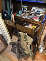 Overall view of wooden shelf with rods, reels, lures, line, vest and boots