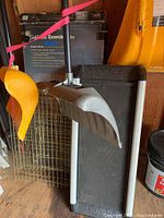 Photo showing boxed Gold Zinc Exercise Pen, a long-handled scoop, and parts of other items around