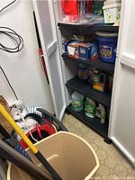 Shelves with various cleaning chemicals and supplies including Odoban, Goo Gone, and CLR.