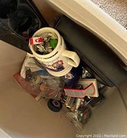 Photo showing white tub containing Avalanche collectibles including mug and figurines.