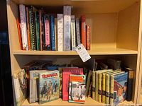 Spine view of cookbooks including vegetarian cooking, food and wine magazines, and Colorado travel and food guides