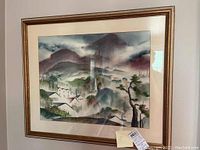 Framed watercolor landscape of village and mountains with gold frame