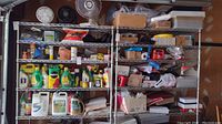 Wide view of metal shelving units filled with assorted garden chemicals, motor oil, boxes, and glassware.