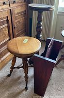 Photo of the piano stool, plant stand, and magazine rack together, showing scale and wood finishes