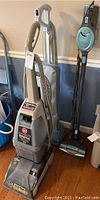 Full view of Hoover SteamVac SpinScrub carpet cleaner and two other vacuums (Oreck and Shark Rocket).
