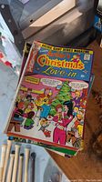 Stack of vintage Archie comics with colorful Christmas themed cover visible
