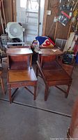 Pair of vintage mahogany end tables with leather tops, front view showing drawer and lower shelf.