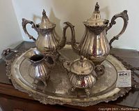 Full view of the 5 piece Wallace Silverplate Baroque tea set including all pieces on the ornate tray showing overall condition and matching design.