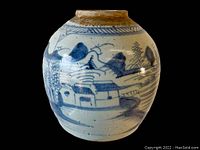 Full front view of the ginger jar showing the detailed blue landscape painting of houses and nature.