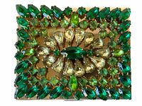 Top closed view showing green and clear rhinestone decoration on gold-tone compact.