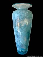 Front and side view of the light blue, cloudy marble effect art glass vase with a flared rim, showing no visible damage.