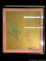 Full view of framed minimalist Japanese illustration on gold silk with pink mat and black frame.