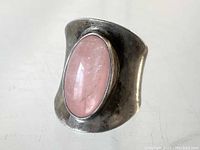 Front view of Danish Modernist silver ring with oval pink stone set in bezel.