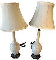 Pair of Art Nouveau crackle glaze ceramic table lamps with fabric shades. Both lamps stand approximately 18 inches tall. One lamp is slightly loose from its metal base as shown.
