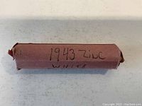 Photo of a wrapped roll of pennies labeled '1943 Zinc White'.
