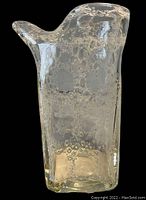 Front view of the unusual square bubble glass vase with a protruding spout-like part and irregular top edge.