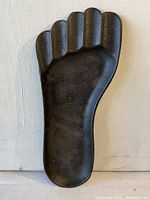 Front view of the Wilton cast iron foot ashtray showing the foot shape and textured surface.