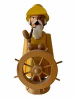 Front view of the yellow wooden fisherman incense burner showing the steering wheel and pipe in mouth.