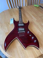 Front view of red BC Rich Masterpiece guitar showing body shape, pickups and controls