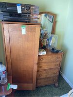 Full view of antique oak wardrobe with door, set of drawers, and mirror on top.