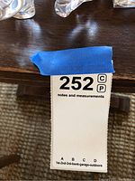 Photo showing lot number and seller notes tape on table