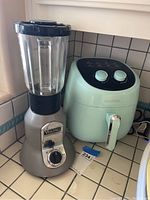 Viking Professional blender and Allcool air fryer side by side on kitchen counter.