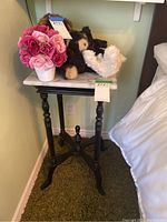 Full view of marble top side table with decorative items placed on top to show scale and surface condition.