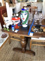 Dining table shown with various glassware and decorative items placed on top for size reference.