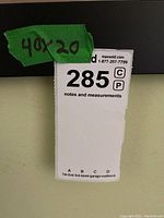 Photo showing green label with written dimensions 40x20 inches on the side of the frame.